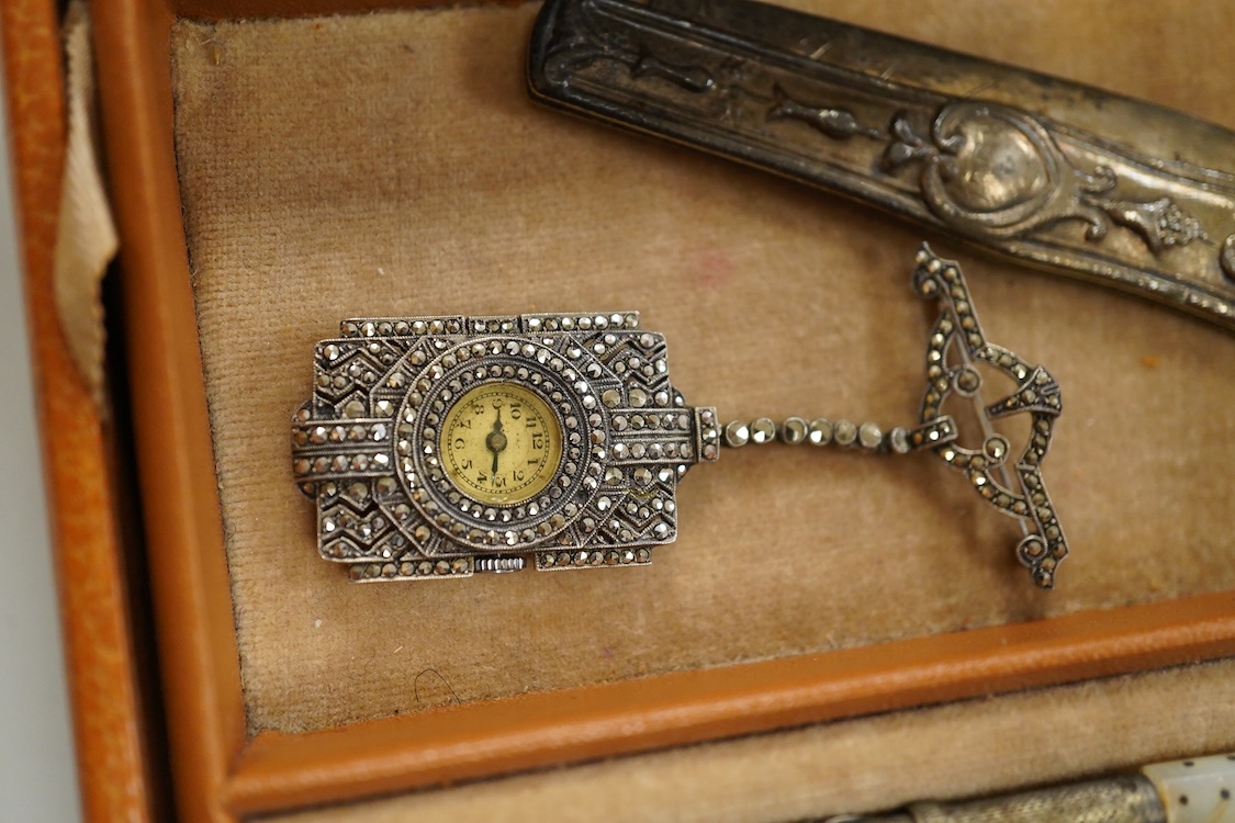 A quantity of assorted antique and later costume jewellery to include a silver and Marcasite ladies fob watch, a collection of cufflinks, brooches and a pair of drop earrings with screw backs